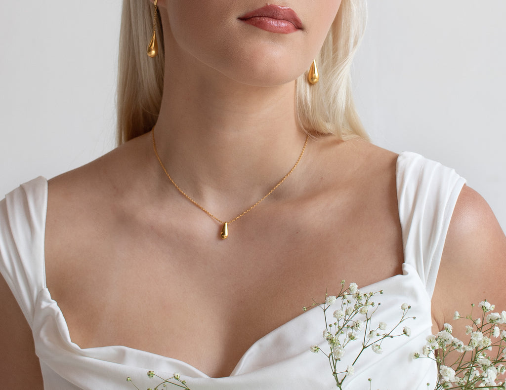 Model showcasing the Sofia Drop Earrings and Sofia Necklace from our Valentine's Day Jewelry Gift Sets, crafted in 18K Yellow gold vermeil, perfect for a romantic and elegant look. 