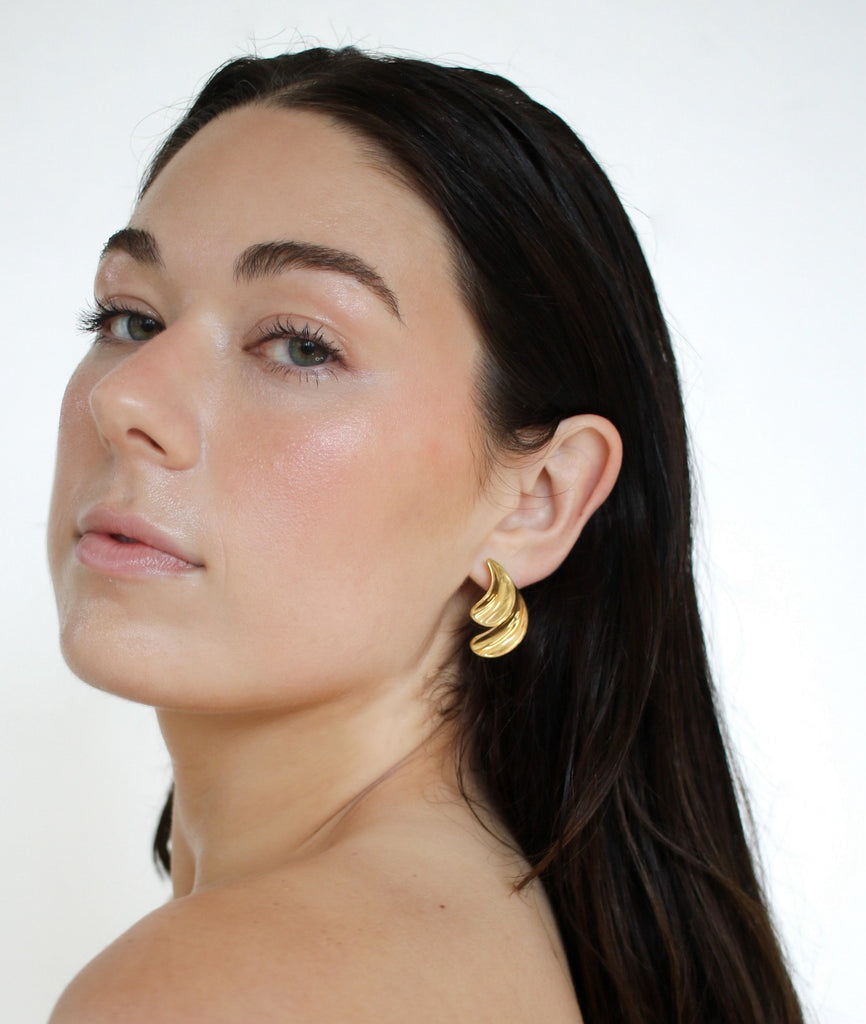 Chic gold Lulu double earrings with a modern design, featuring two interconnected hoops for a stylish and sophisticated look.