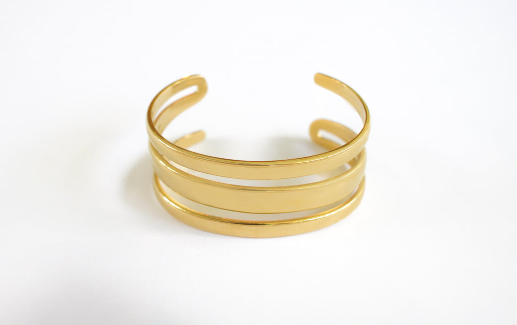 Stylish gold Lulu bangle bracelet with a sleek design, perfect for stacking or wearing solo for a touch of elegance.