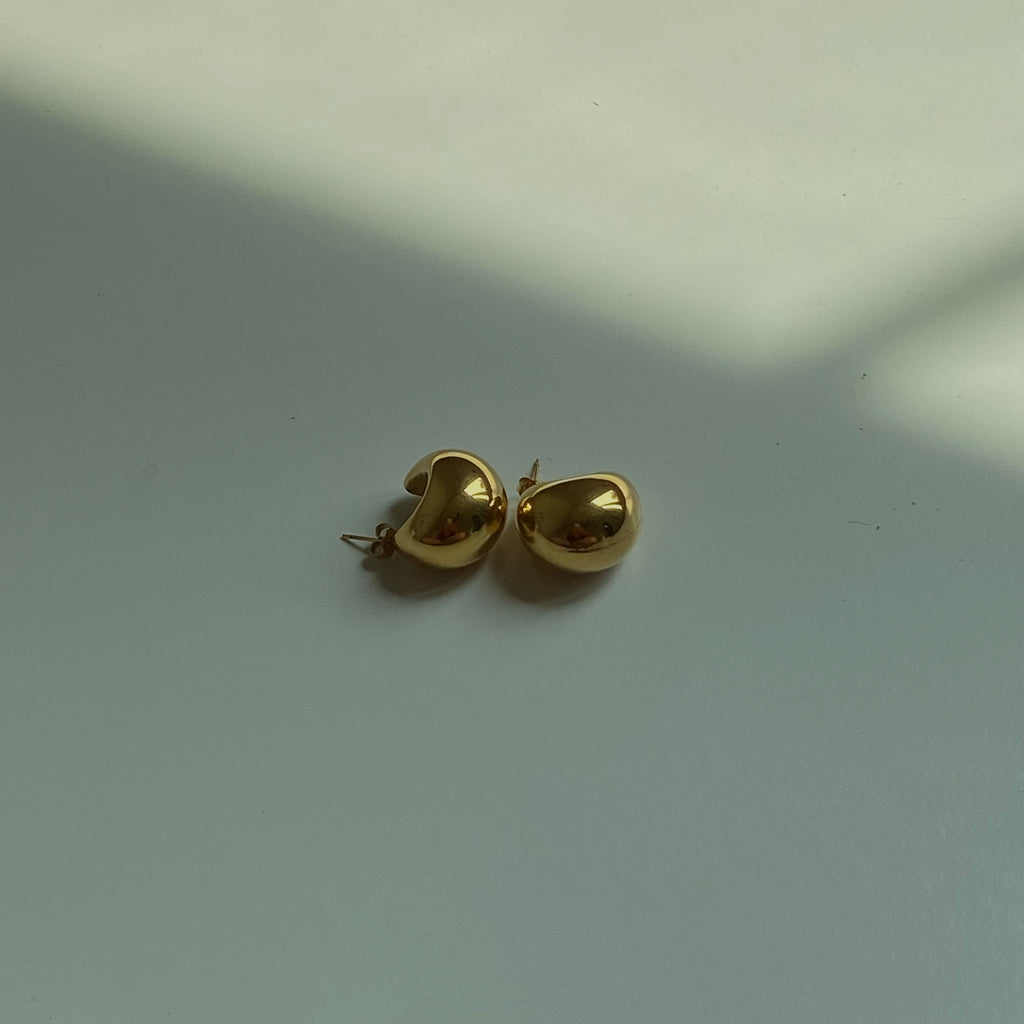 Stylish gold hoop earrings featuring a sleek, minimalist design.