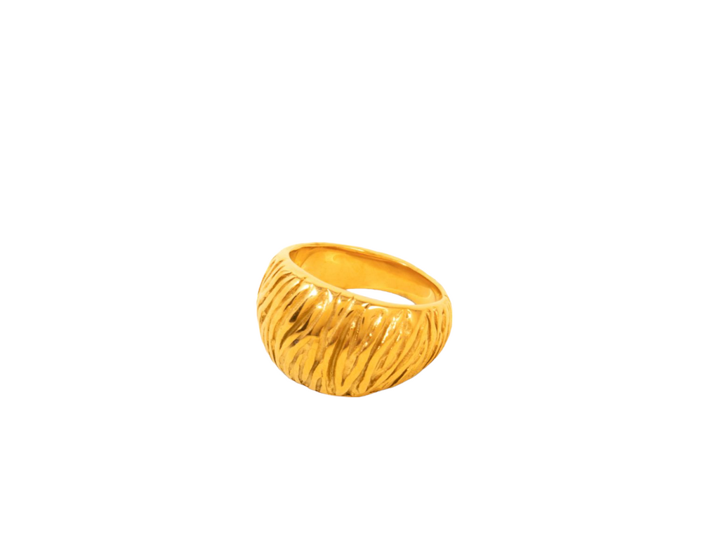 Stylish gold ring featuring a unique zebra imprint on the band for a bold, textured look.