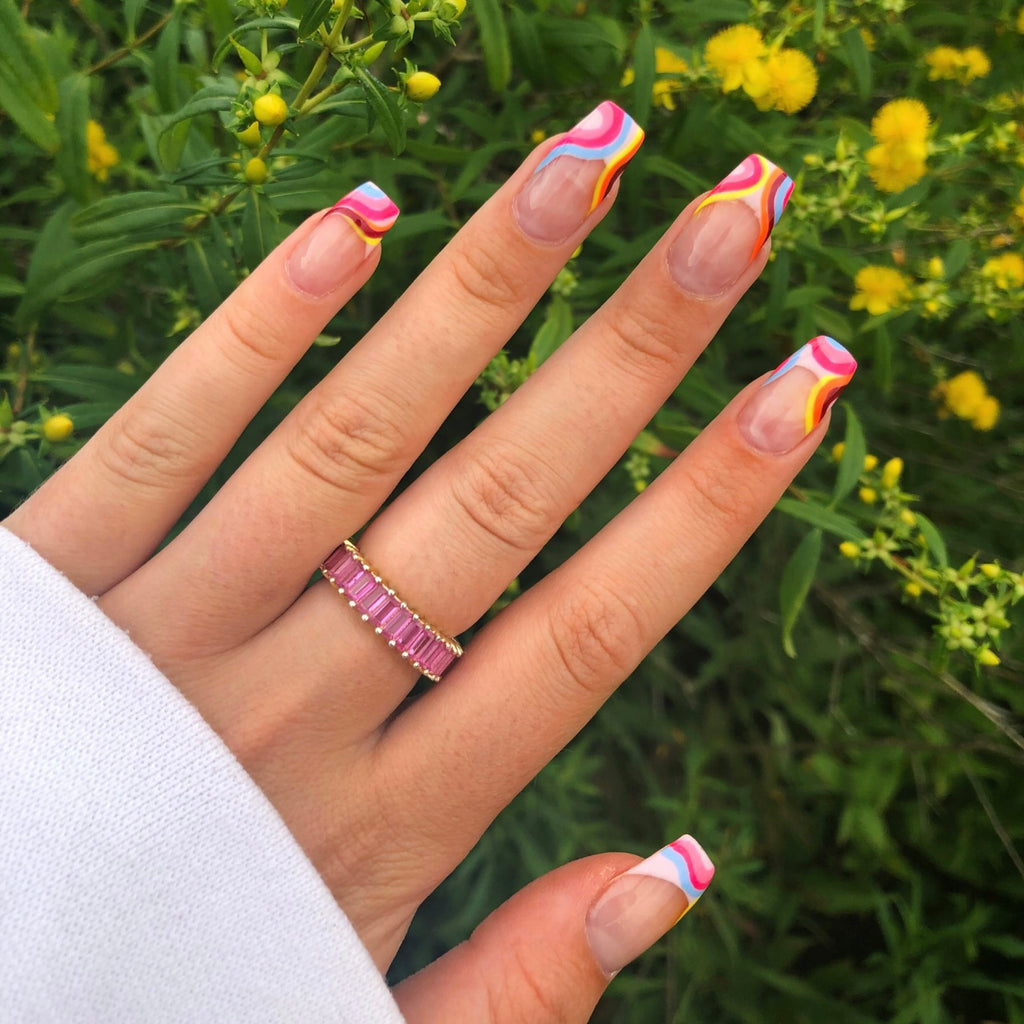 Elegant pink ice ring showcasing a vibrant pink stone encircled by shimmering accents, designed in sleek metal for a modern and eye-catching accessory.